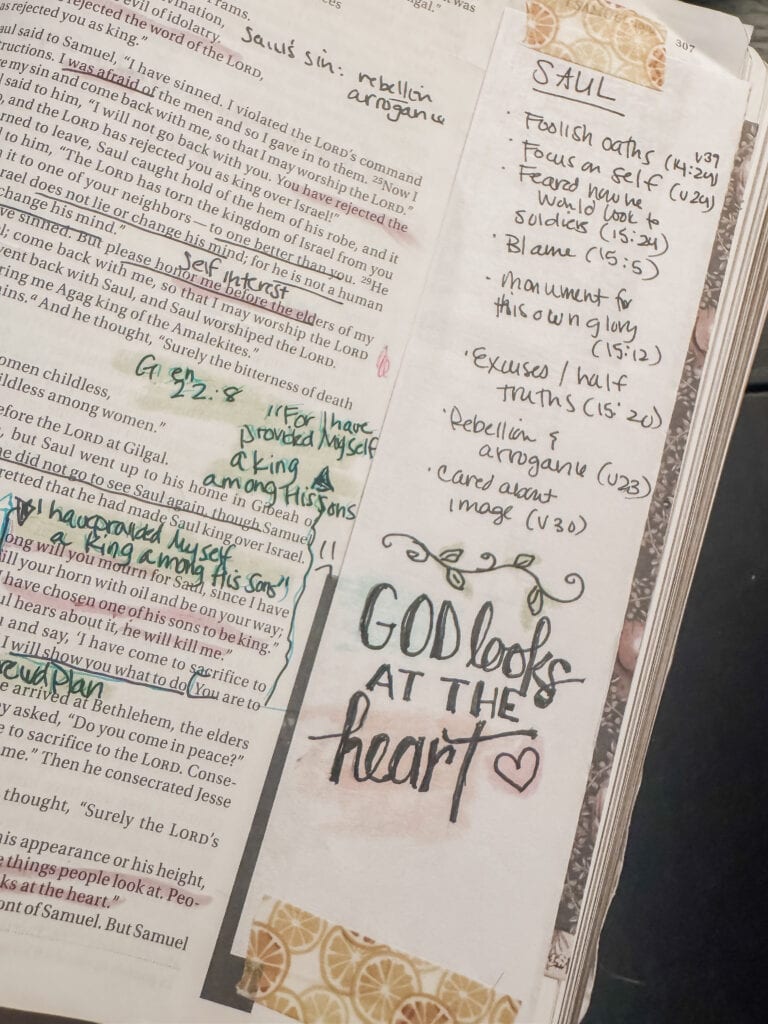 Close-up of a Bible journal page with handwritten notes, decorative elements, and the phrase 'God looks at the heart' with a heart symbol, emphasizing faith and reflection.