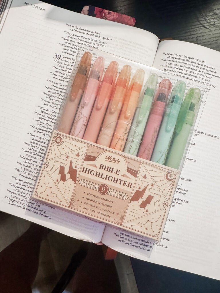 A set of nine pastel-colored Bible highlighters placed on an open book, highlighting scripture passages, with a focus on gentle, vibrant colors for Bible study and note-taking.