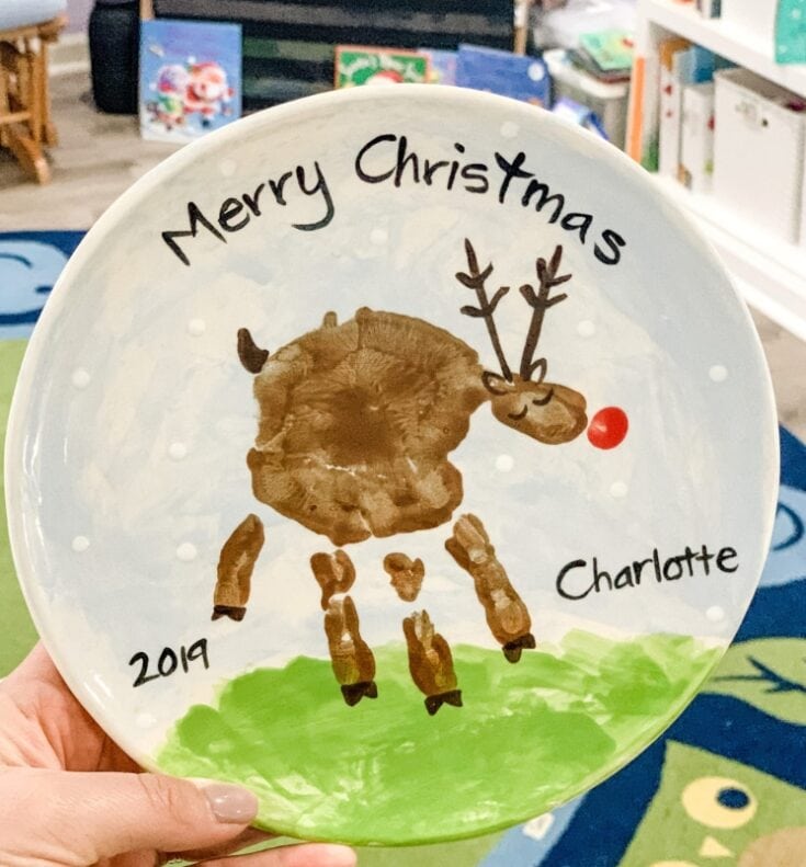 Hand-painted ceramic plate with a reindeer design, Christmas greeting, and personalized name Charlotte, perfect for holiday decor or gifts.