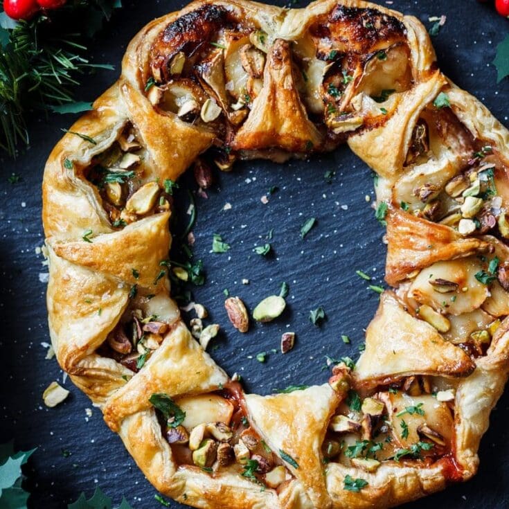 Delicious mushroom and herb puff pastry tart garnished with chopped nuts and fresh herbs, perfect for appetizers or brunch, from A Hundred Affections.
