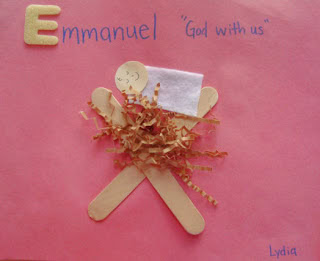 Creative Emmanuel craft made with popsicle sticks, tissue paper, and paper face on pink background, suitable for preschool and Sunday school activities.