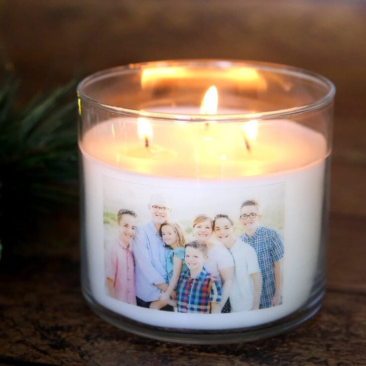 A family photo printed on a candle in a glass holder, creating a warm and personalized home decor piece with a flickering flame.