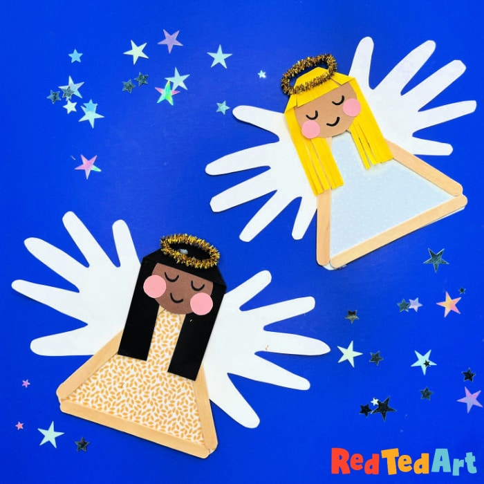 Two angel crafts with paper wings, halo, and smiling faces on a blue background with star confetti, perfect for children's art projects.