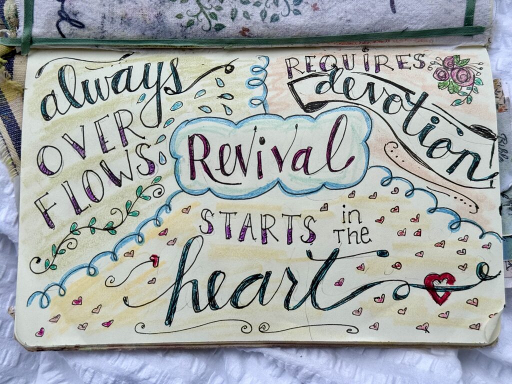 Colorful handwritten quote about revival and love, featuring decorative elements like hearts, flowers, and swirls, on a creative journal page.