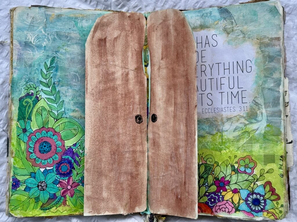 Colorful floral artwork on a decorated Bible journal with a wooden cover and a Bible verse from Ecclesiastes 3:11, emphasizing God's perfect timing and creation.