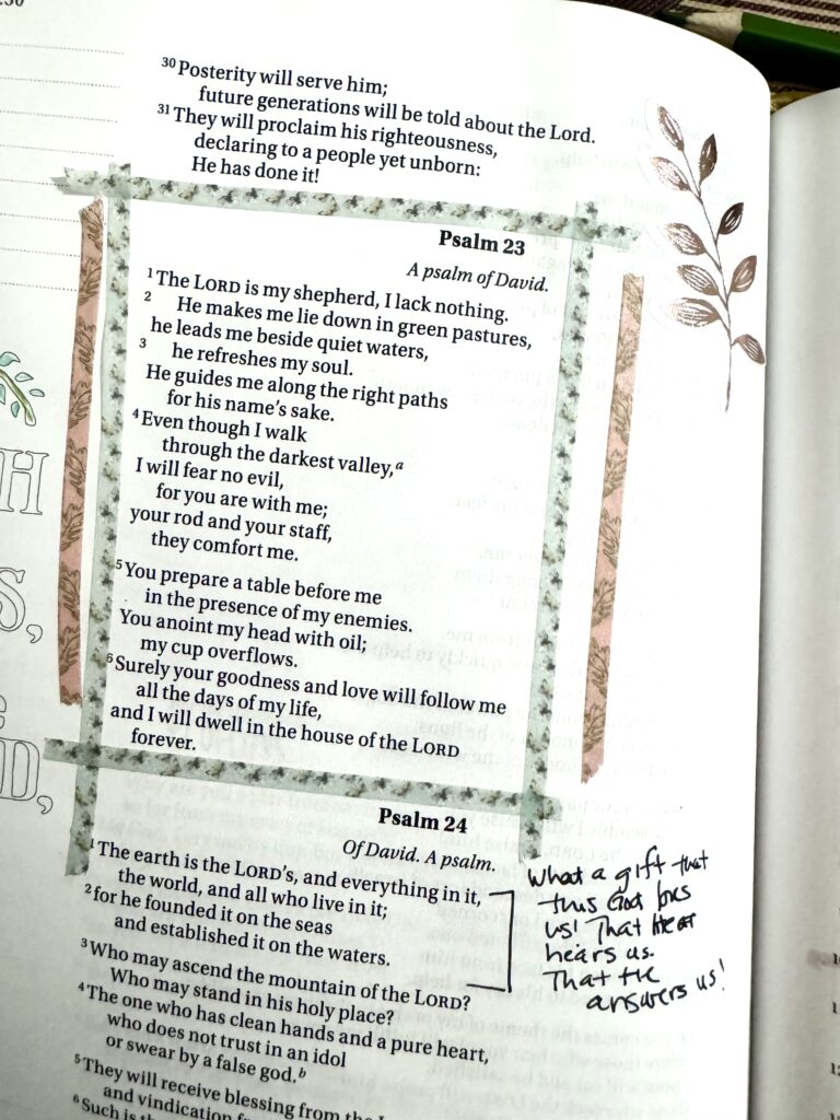 Close-up of a handwritten Bible journal page featuring Psalm 23 and 24, with decorative leaf illustrations and personal notes, emphasizing faith and devotion.