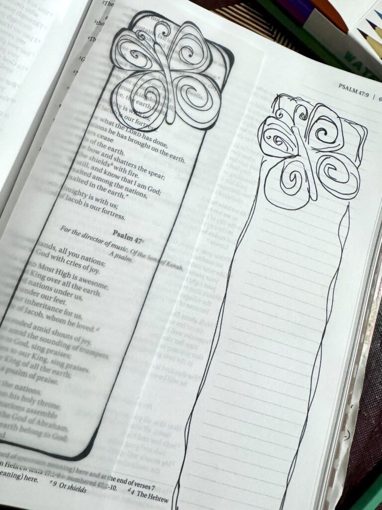 A detailed hand-drawn floral design on a Bible page, with a pencil sketch of a flower with swirling petals and a long stem, placed on an open Bible with text.