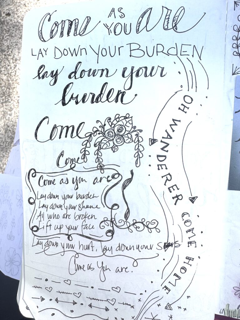 Handwritten quote art with motivational message about coming as you are and laying down burdens, featuring decorative floral and swirl designs.