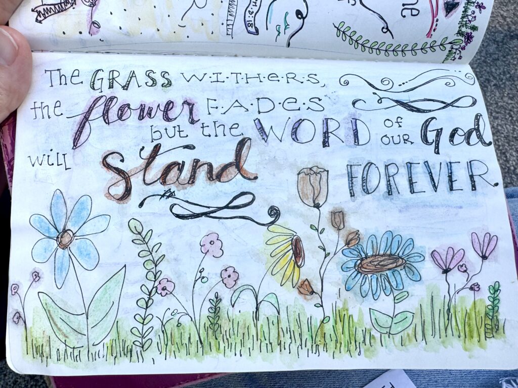 Colorful hand-drawn quote about faith and love surrounded by vibrant flowers and greenery, emphasizing hope and spirituality for inspirational decor.