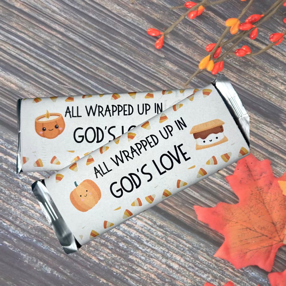 Printable Christian Halloween candy bar wrappers with faith-based message and cute fall-themed illustrations for festive treats.