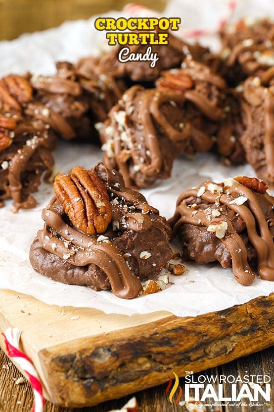 Crockpot turtle candies featuring pecan halves, chocolate drizzle, and a sprinkled finish on parchment, inspired by A Hundred Affections for indulgent dessert treats.