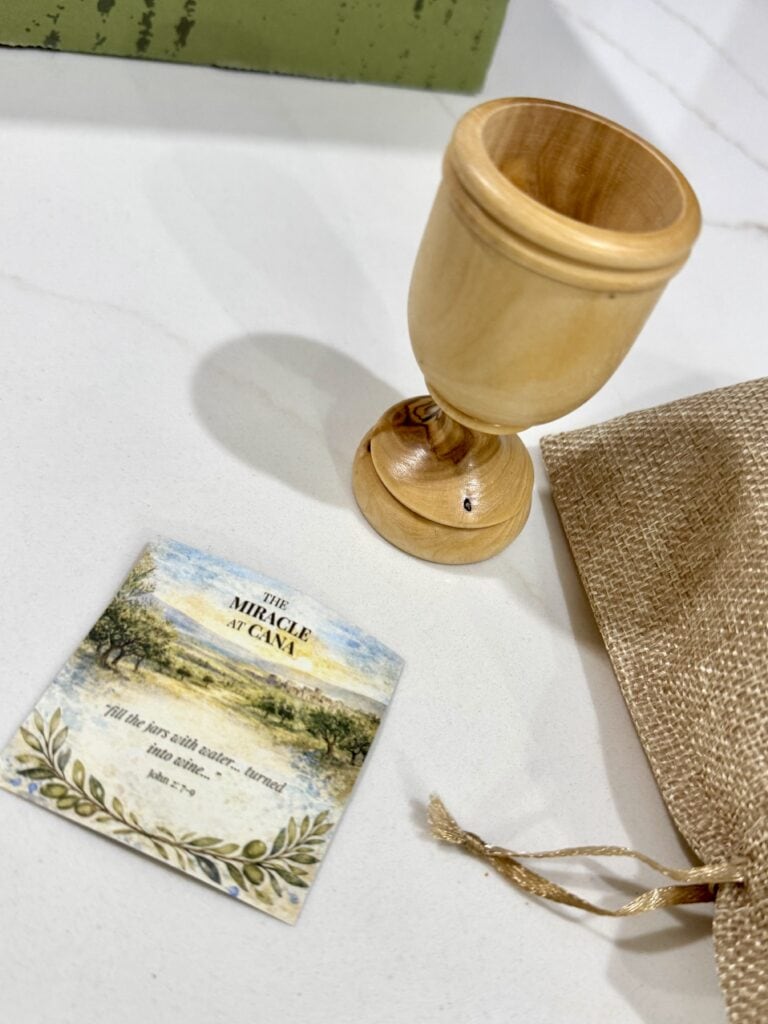Wooden chalice, card with artwork titled The Miracle at Cana, burlap pouch from Artza Box