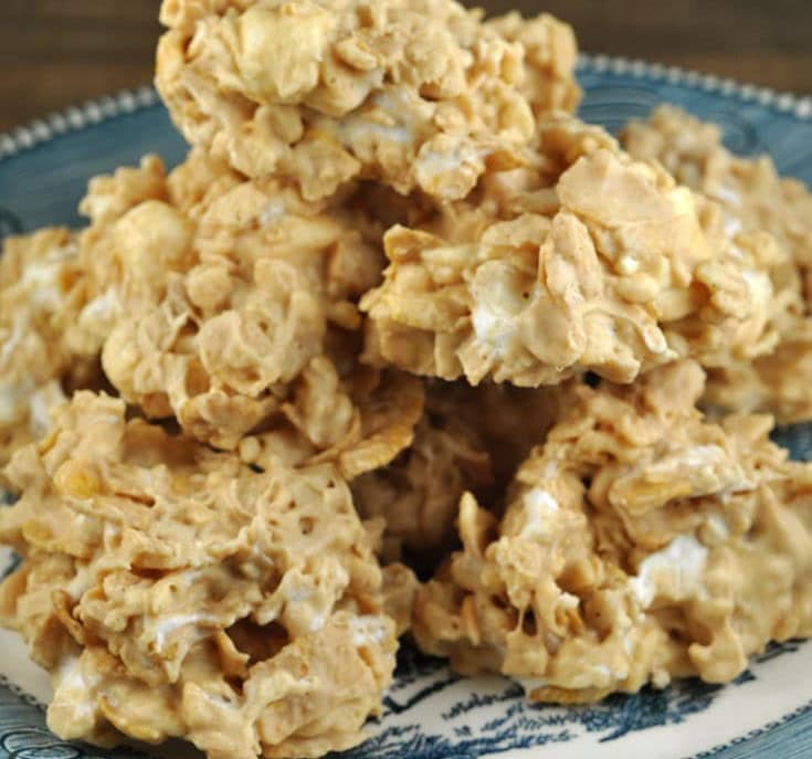 A plate of crunchy peanut butter rice crispy treats, golden brown clusters with creamy nougat-like texture, perfect snack from A Hundred Affections.