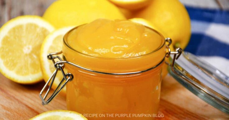 A bright jar of lemon jam with fresh lemon halves in the background, highlighting a sweet citrus spread from A Hundred Affections for a delicious breakfast or snack.
